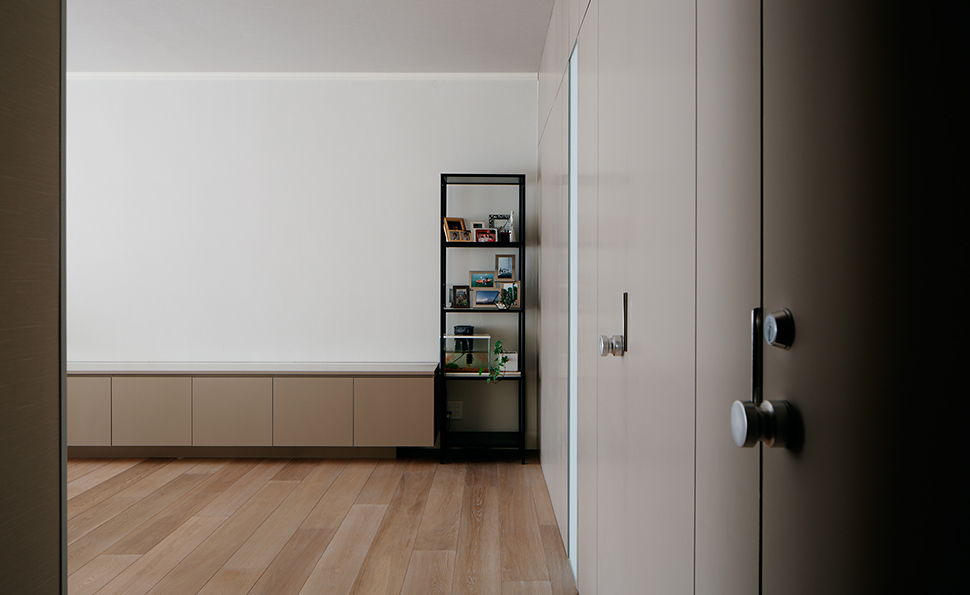 廊下からリビングを見る<br />パネルと壁面収納の色を統一