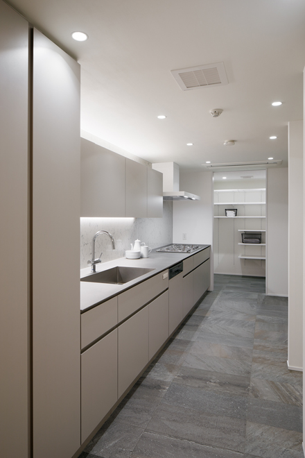 ダイニング側から見たキッチン　奥にはパントリー兼ランドリーがあり生活感を隠せる